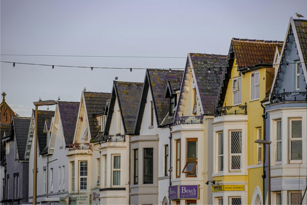 How Do I Find Out Who My Neighbors Homeowners Insurance Is? Row of neighboring homes representing property insurance lookup concerns