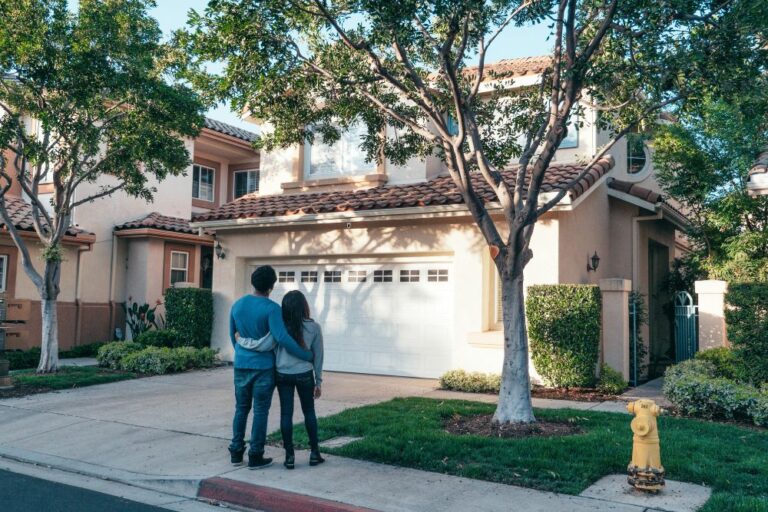 Couple standing outside home representing trusted homeowners insurance from Portsmouth Atlantic Insurance, most reviewed independent agency in New Hampshire