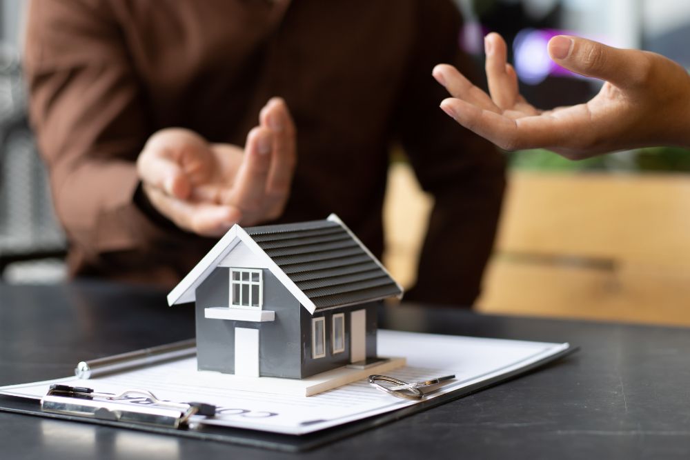 Homeowners discussing coverage costs, how much is home insurance in Massachusetts for protecting your home and property
