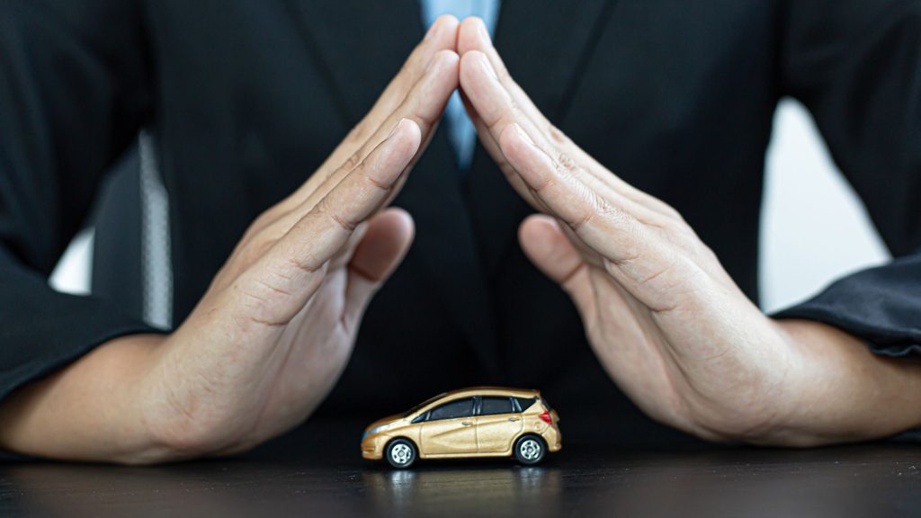 Hands forming a roof over a toy car