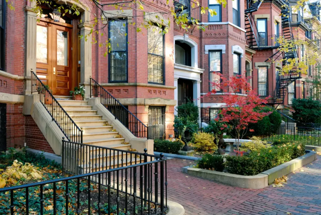 Brick rowhouses with front stoops and iron railings in Boston's Back Bay