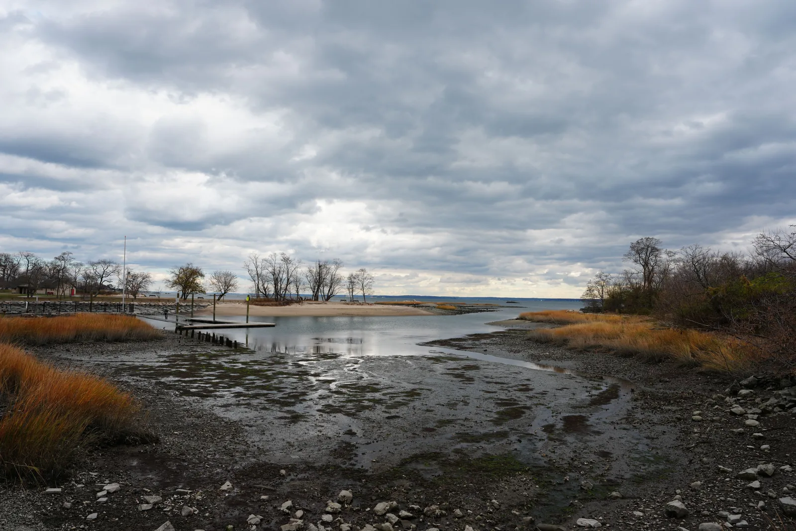 Storm clouds over a Connecticut shoreline marsh and inlet with wind-blown beach grass