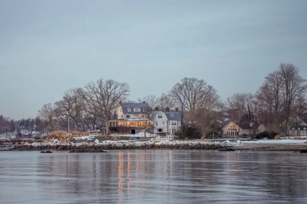 Shoreline home reflected in the water at dusk in Stamford, Connecticut